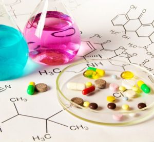 Chemicals in vials next to range of pills