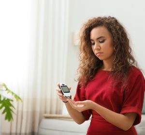 Diabetic woman taking blood glucose levels