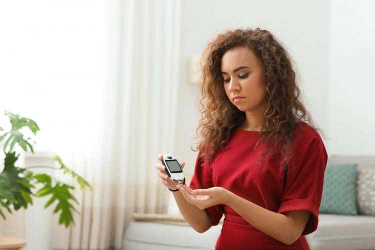 Diabetic woman taking blood glucose levels