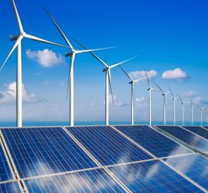 Wind turbines lined up behind solar panels