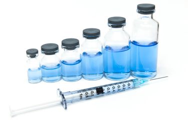 Blue medicine and syringe