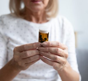 Woman holding pill bottle