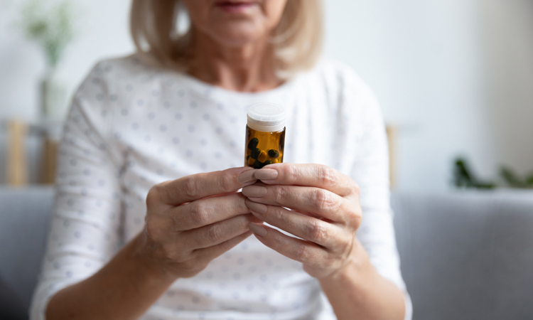 Woman holding pill bottle