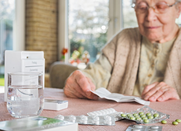 Elderly person reading medication leaflet for ePI article