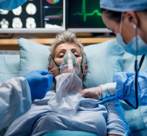 Infected patient in hospital bed with oxygen