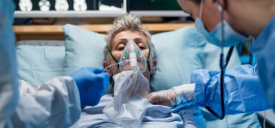 Infected patient in hospital bed with oxygen