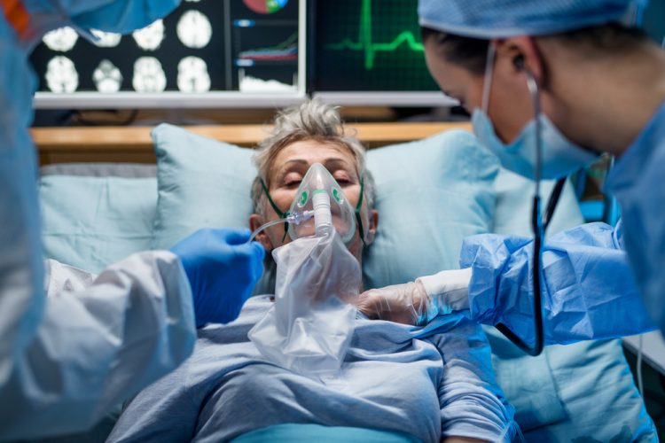 Infected patient in hospital bed with oxygen