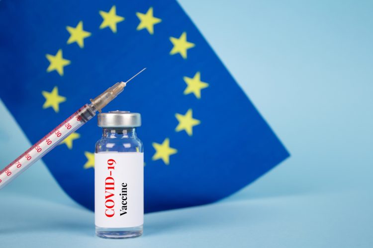COVID-19 vaccine in front of EU flag