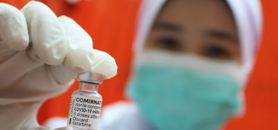 Doctor holding Comirnaty vaccine vial
