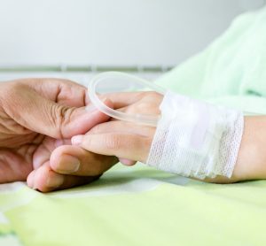 Close-up of hand of child with leukaemia receiving chemotherapy