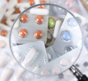 Pills under magnifying glass
