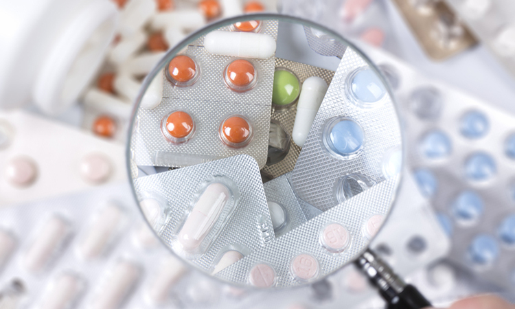 Pills under magnifying glass