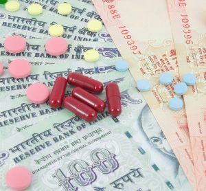 Pills lying on rupee notes