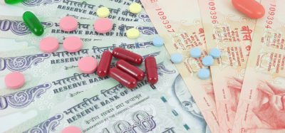 Pills lying on rupee notes