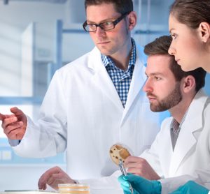 Scientists in lab looking at a computer