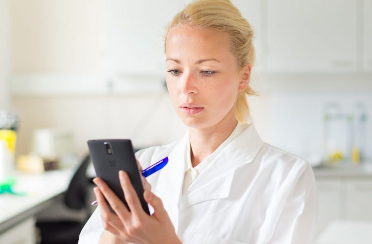 Scientist on mobile phone - COVID-19 app