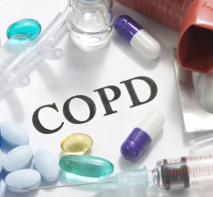 Paper with COPD written on it and surrounded by medicines