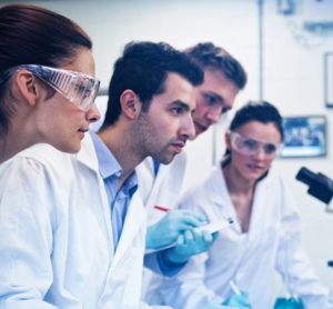 Scientists in lab looking at screen