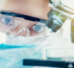 Female scientist looking at microscope