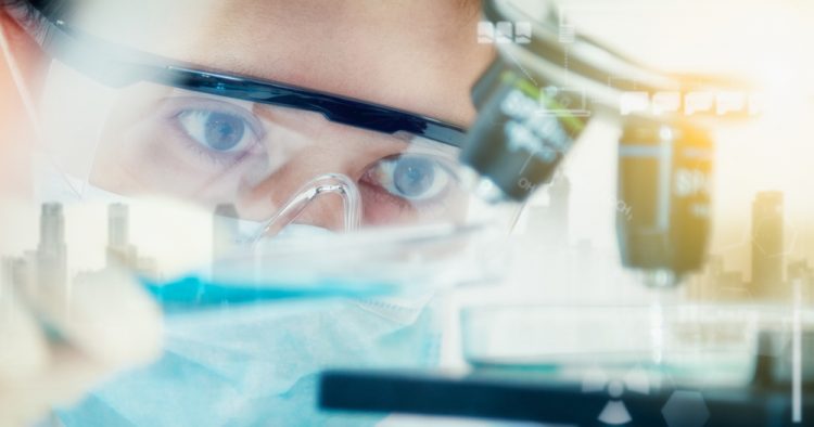 Female scientist looking at microscope