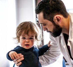 Child with dwarfism with doctor