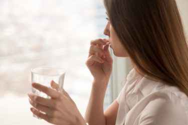 Woman taking pill