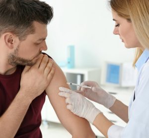 Doctor vaccinating man