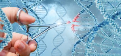 Hands cutting DNA strand with scissors, gene therapy concept