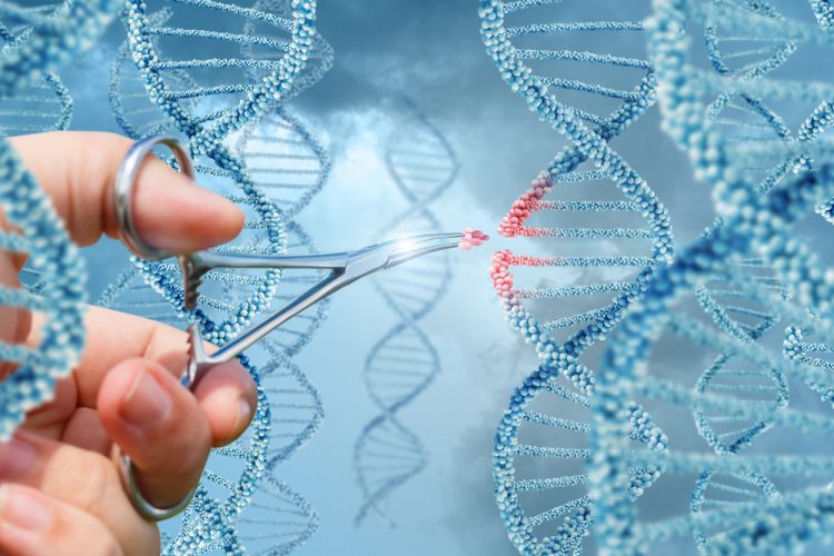 Hands cutting DNA strand with scissors, gene therapy concept