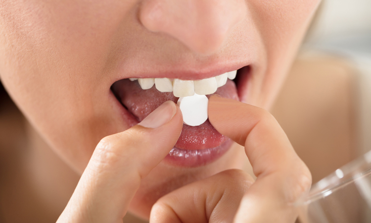 Woman taking tablet