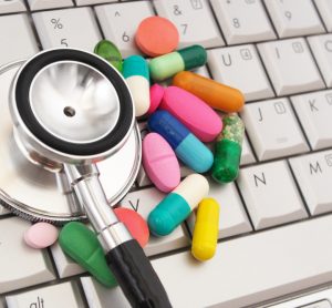 Pills and stethoscope on keyboard