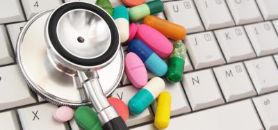 Pills and stethoscope on keyboard
