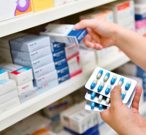 Woman shopping for pills at pharmacy