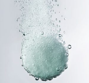 White dissolving tablet with bubbles