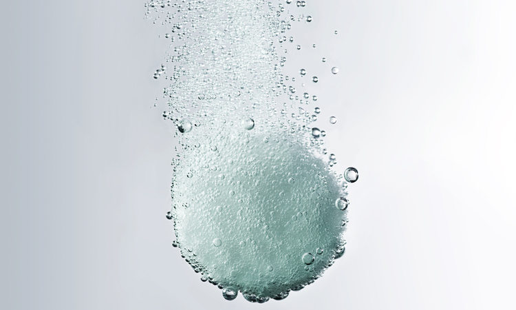 White dissolving tablet with bubbles