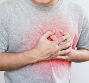 Man clutching heart, implying heart failure