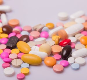 pile of tablets/pills of various different sizes and colours