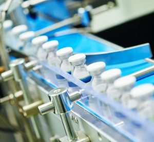 vials of liquid for injection being labelled on a production line