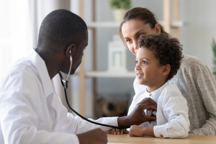 Doctor using stethoscope on child