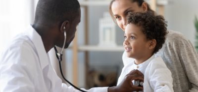 Doctor using stethoscope on child