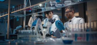 Student and pharmaceutical professional in lab