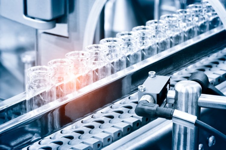 Vaccine manufacturing idea - Glass bottles in production in the tray of a liquid vending machine;  a filling line for drugs such as vaccines