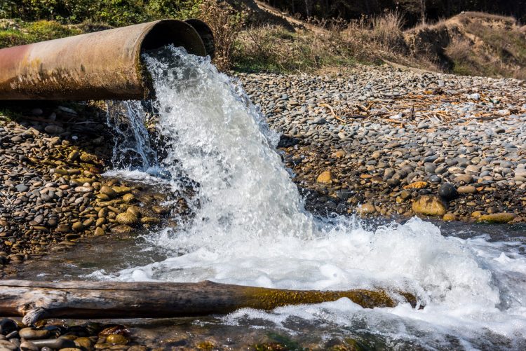 wastewater pipe releasing water into a stream