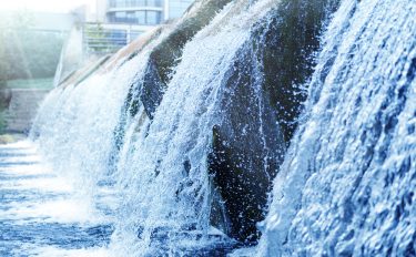 water flowing over a waterfall from a wastewater treatment plant